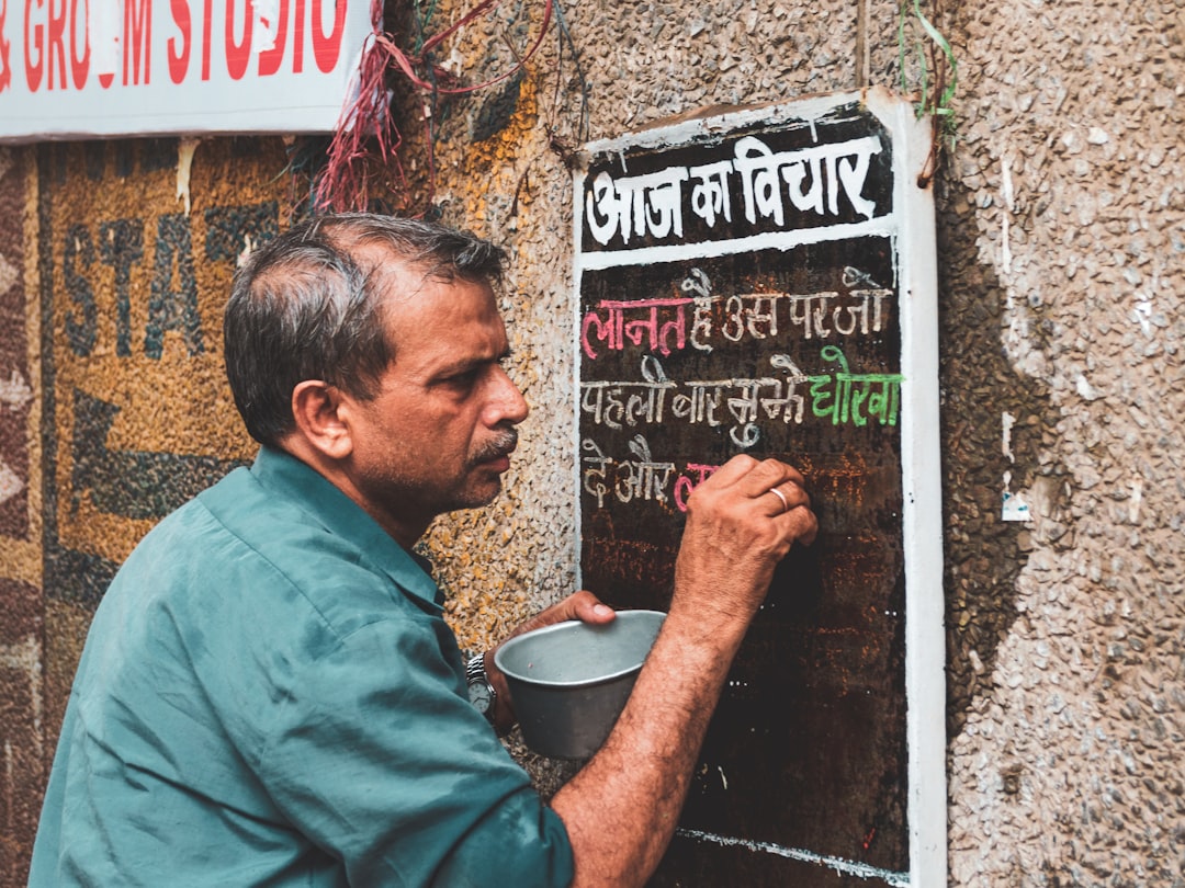 A vibrant illustration showing a 'hawk' (representing RBI) watching over a graph depicting 'inflation' going down, and another graph showing 'interest rates' going up. Below, there are two small icons: one of a rising EMI arrow and another of a SIP graph with dips and eventual rise, symbolizing rupee cost averaging. Alt text: RBI's Hawkish Stance controlling inflation with rising interest rates, impacting EMIs and showing SIP benefits during market dips.